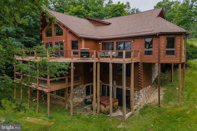 back of house with a lawn and a deck