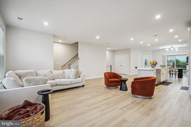 living room featuring light hardwood / wood-style floors and an inviting chandelier