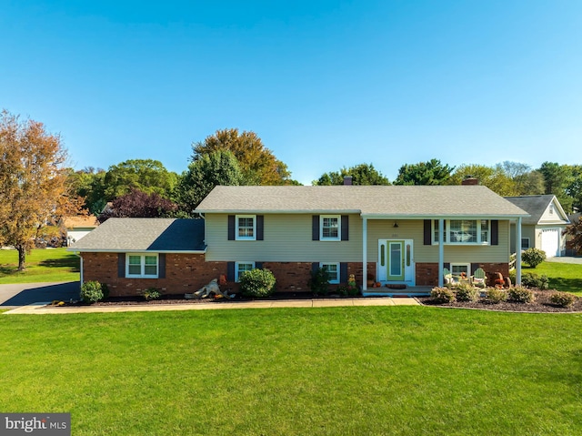 bi-level home featuring french doors, a front yard, and a garage