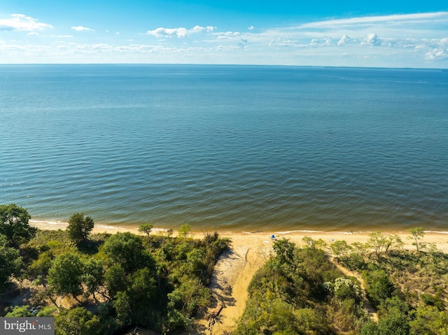 birds eye view of property featuring a water view and a beach view