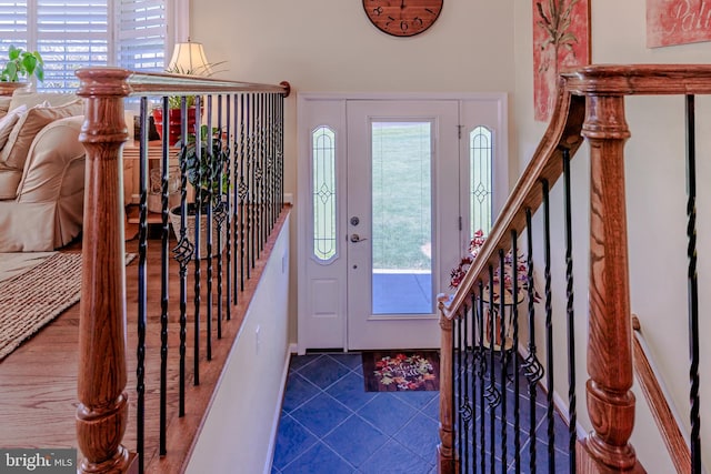 foyer with plenty of natural light and tile patterned floors