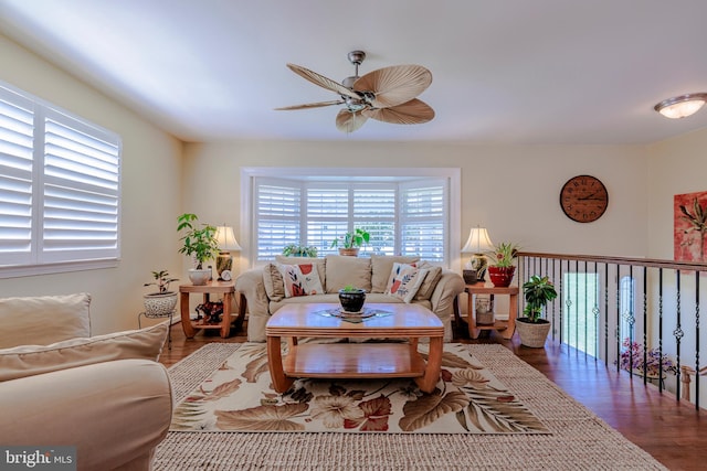 living room featuring dark hardwood / wood-style flooring and ceiling fan