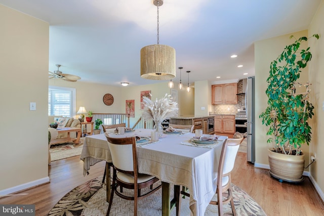 dining area with light wood-type flooring, baseboards, beverage cooler, and recessed lighting