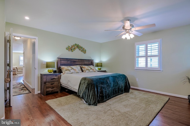 bedroom with ceiling fan and dark hardwood / wood-style floors