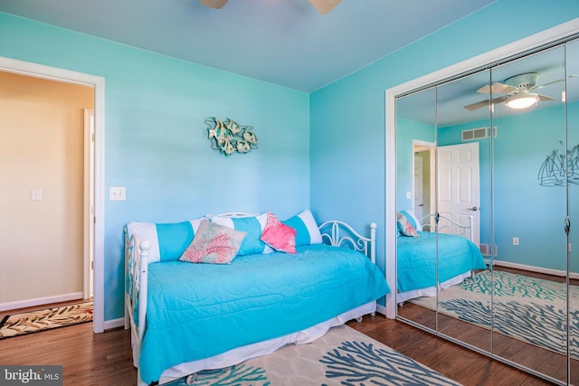 bedroom with visible vents, baseboards, a ceiling fan, and wood finished floors