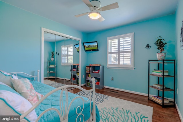 bedroom featuring a closet, hardwood / wood-style flooring, and ceiling fan