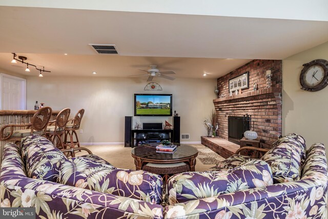 living room featuring ceiling fan, a fireplace, and carpet flooring