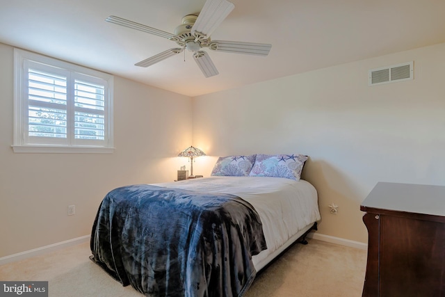 bedroom with light carpet and ceiling fan