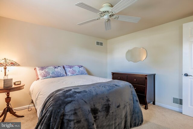 bedroom with ceiling fan and light colored carpet