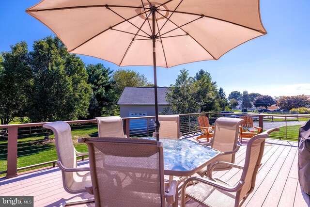 wooden deck featuring a yard