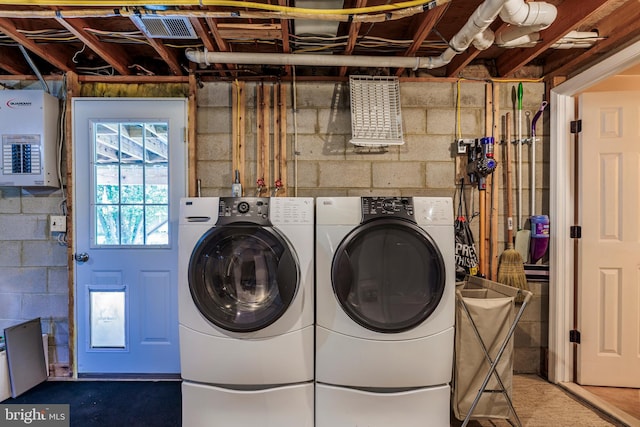 laundry room with electric panel and separate washer and dryer