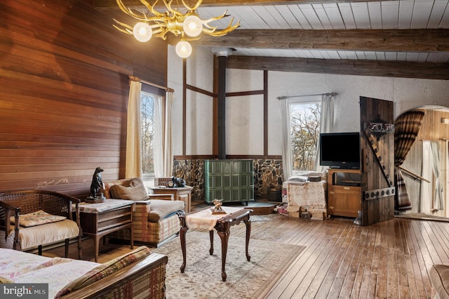 sitting room featuring vaulted ceiling with beams, wood ceiling, hardwood / wood-style flooring, and a healthy amount of sunlight