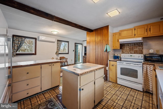 kitchen with a wall unit AC, electric range, plenty of natural light, and a kitchen island