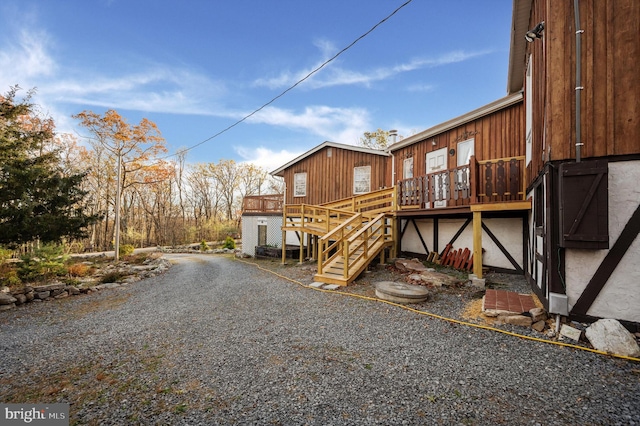 rear view of house featuring a wooden deck