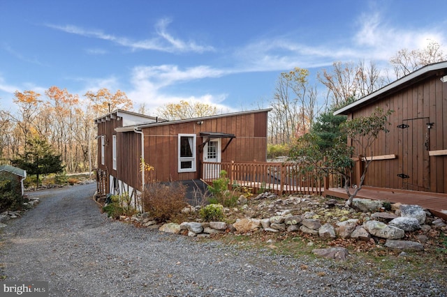 view of property exterior featuring a wooden deck