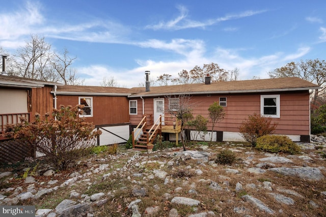 rear view of property with a wooden deck