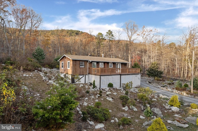 back of property with a wooden deck