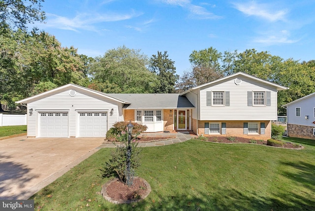 tri-level home with a garage and a front lawn