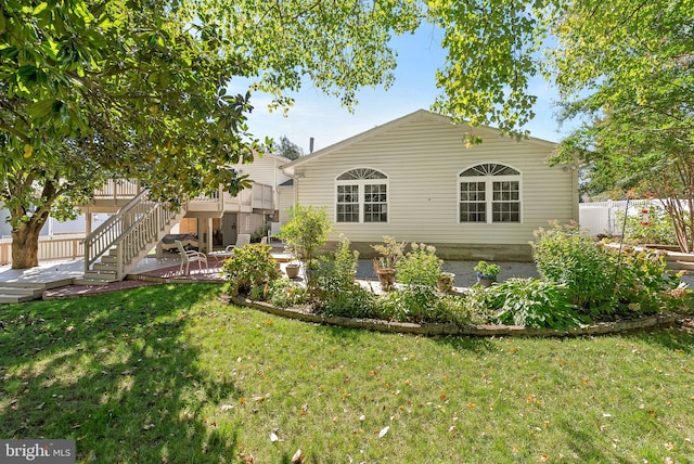 rear view of house with a yard and a patio area