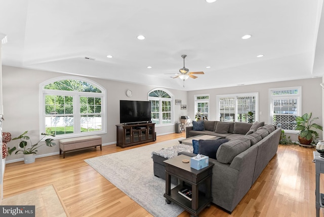 living room featuring ceiling fan and light hardwood / wood-style floors