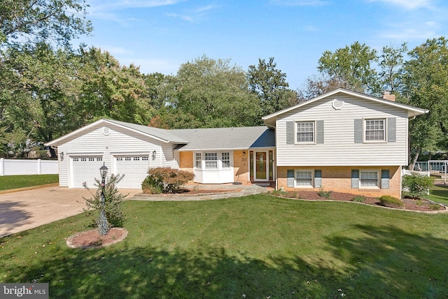 tri-level home with a front yard and a garage