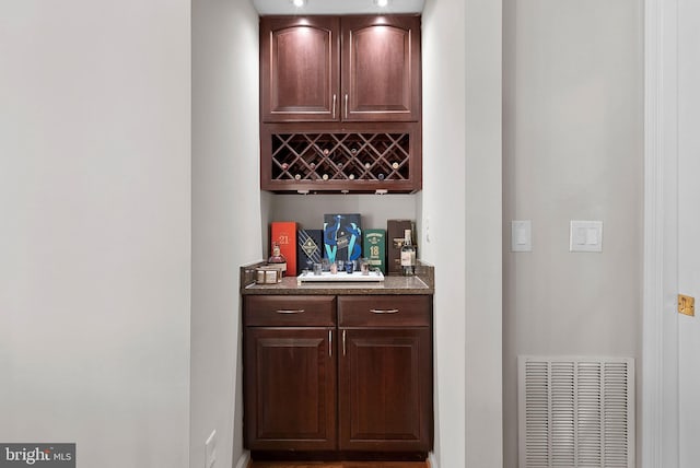 bar with dark brown cabinetry