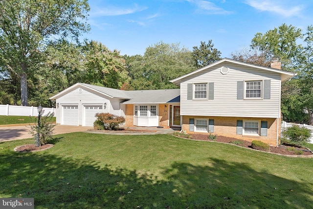 split level home with a front lawn and a garage