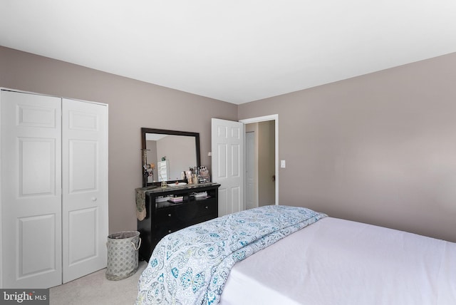 bedroom featuring a closet and carpet flooring