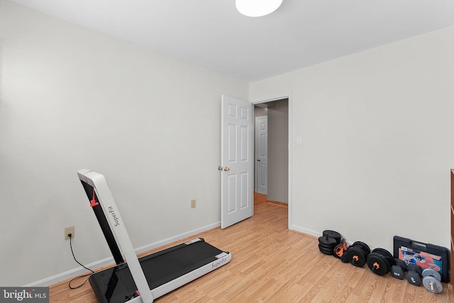 workout room with light hardwood / wood-style flooring