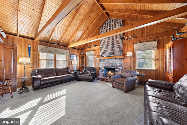 carpeted living room with beam ceiling, wooden ceiling, a brick fireplace, and wooden walls