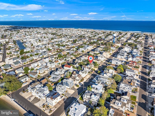 birds eye view of property featuring a water view and a view of the beach