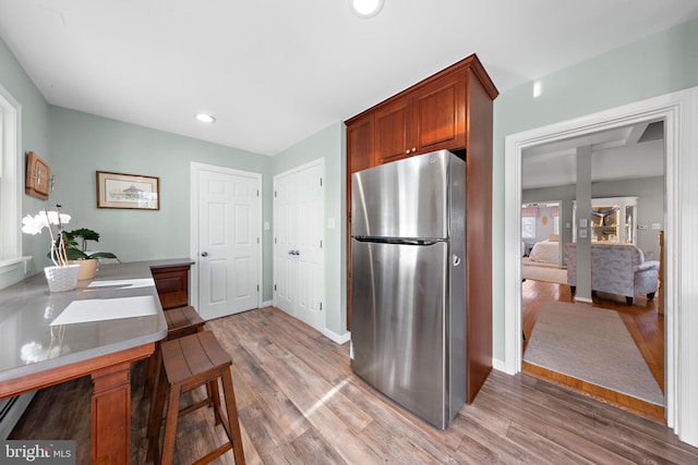 kitchen featuring light hardwood / wood-style floors and stainless steel refrigerator