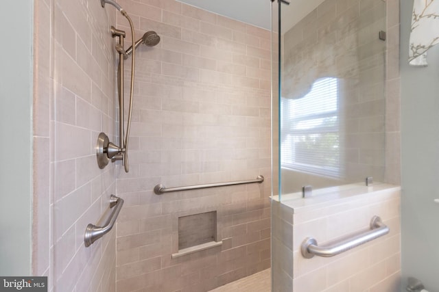 bathroom with tiled shower