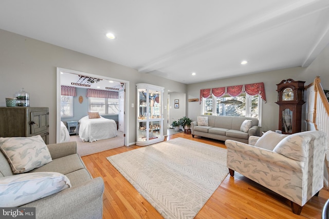 living room featuring hardwood / wood-style floors and beamed ceiling