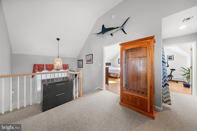 interior space with light carpet and vaulted ceiling