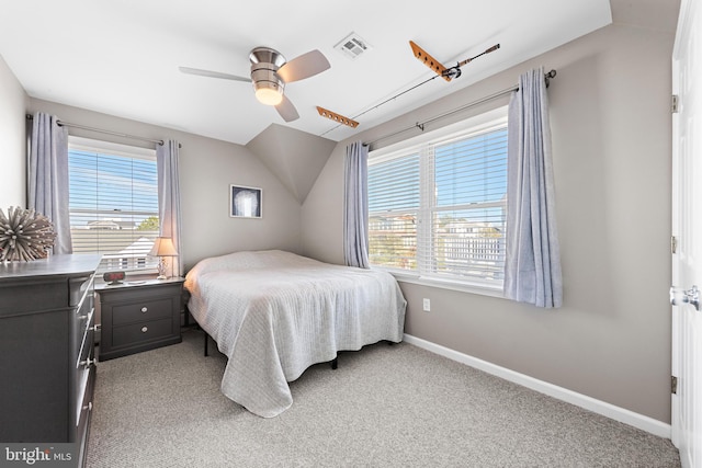 carpeted bedroom featuring multiple windows, lofted ceiling, and ceiling fan