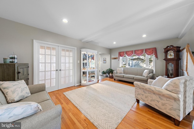 living room with beamed ceiling, french doors, and light wood-type flooring