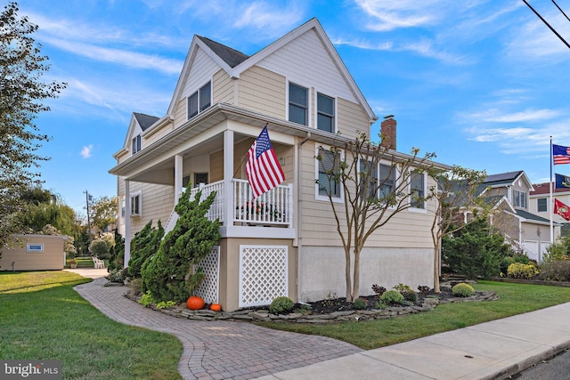 view of front of property with a porch and a front yard