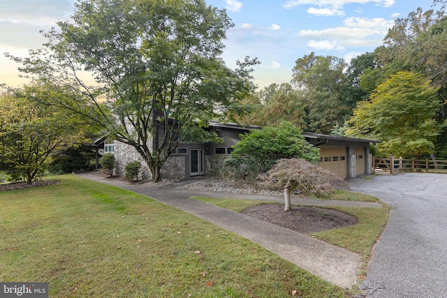 view of front of house with a garage and a yard