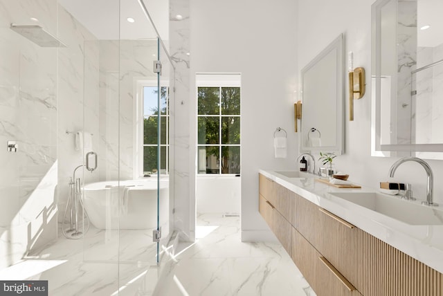 bathroom with vanity and shower with separate bathtub