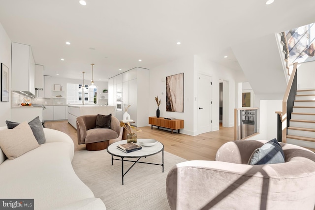 living room featuring light wood-type flooring and a healthy amount of sunlight