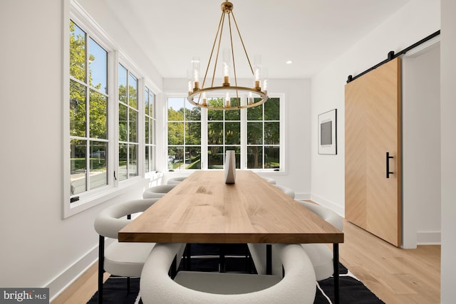 sunroom / solarium with a barn door and a chandelier