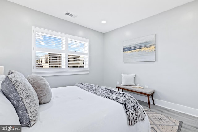 bedroom with hardwood / wood-style flooring