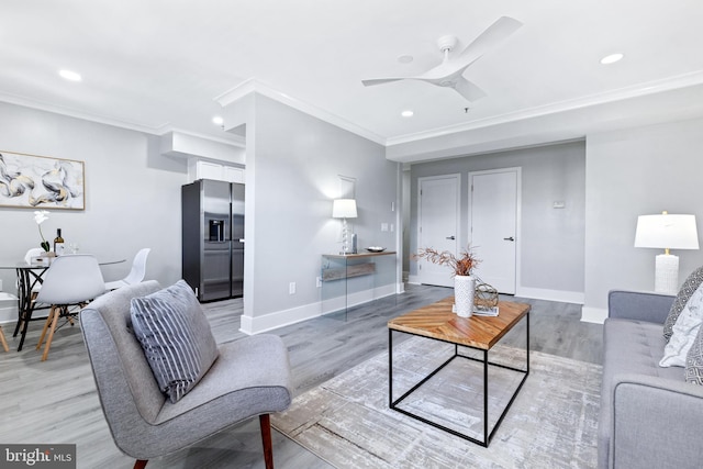 living room featuring wood-type flooring, crown molding, and ceiling fan