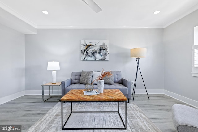 living room featuring ornamental molding, hardwood / wood-style flooring, and ceiling fan