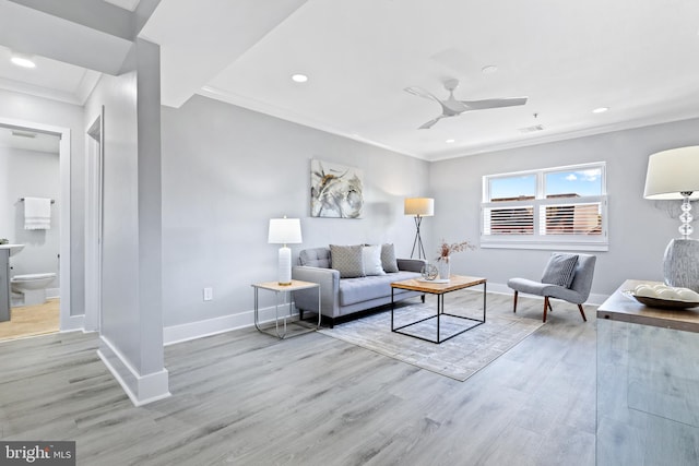 living room featuring ornamental molding, ceiling fan, and light hardwood / wood-style flooring