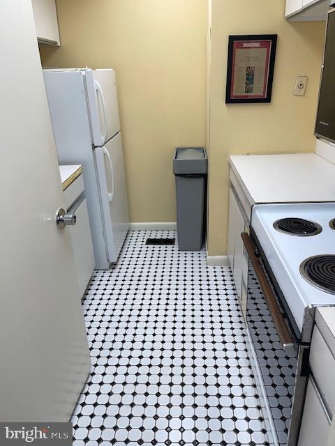 kitchen with range with electric cooktop and white fridge