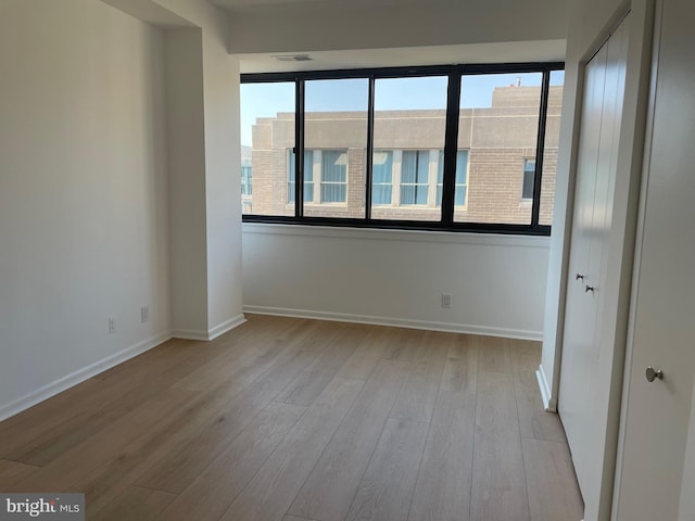 unfurnished room with light wood-type flooring