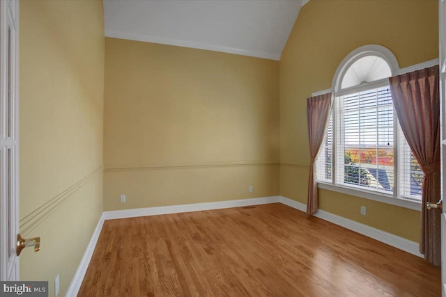 unfurnished room with vaulted ceiling and light hardwood / wood-style floors