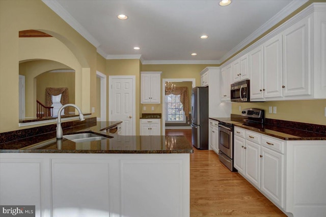 kitchen featuring sink, white cabinetry, light hardwood / wood-style flooring, and stainless steel appliances